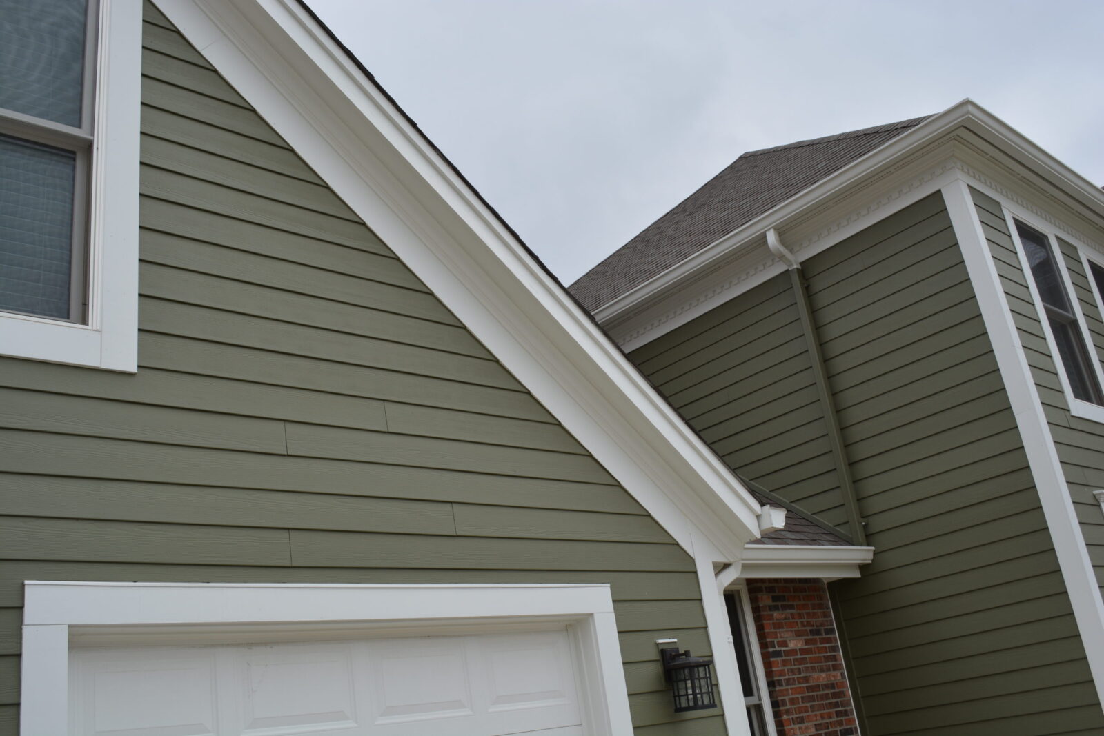 James Hardie Mountain Sage lap siding with Arctic White frieze and roofline trim