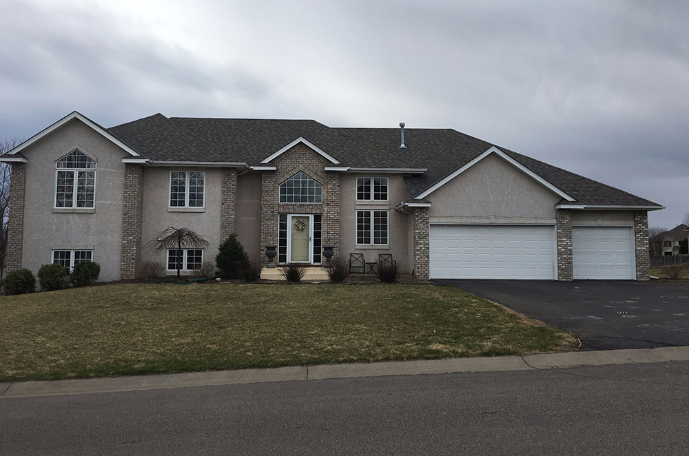 Lakeville MN home with original stucco before siding and window replacement