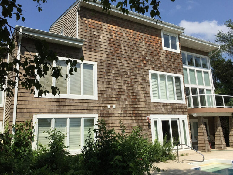 Rear view of Chanhassen home with old cedar shakes showing fading and wear before remodel.