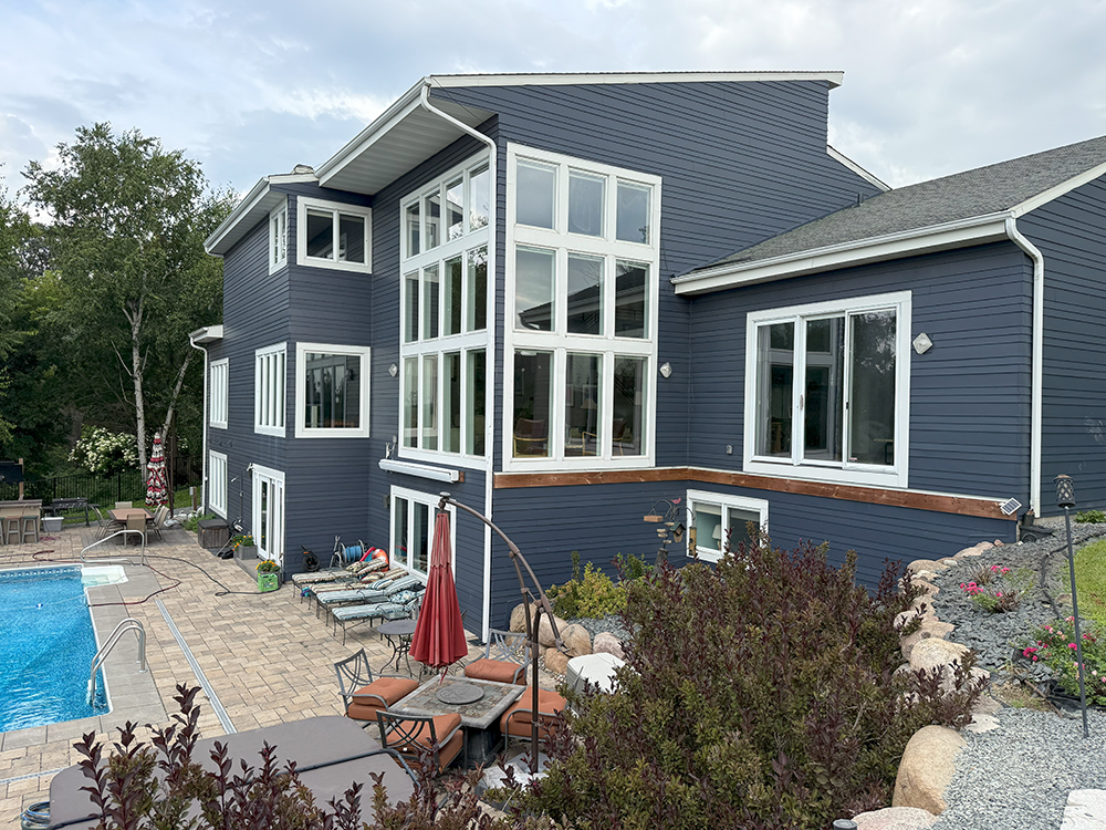 Completed remodel of Chanhassen home with James Hardie Deep Ocean siding replacing weathered cedar shakes.