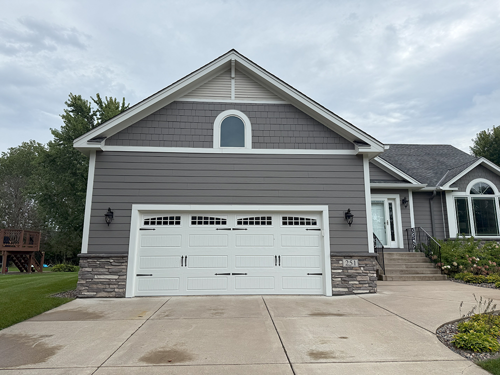 Custom gable details with Arctic White trim and Fypon brackets on James Hardie project in Lino Lakes.
