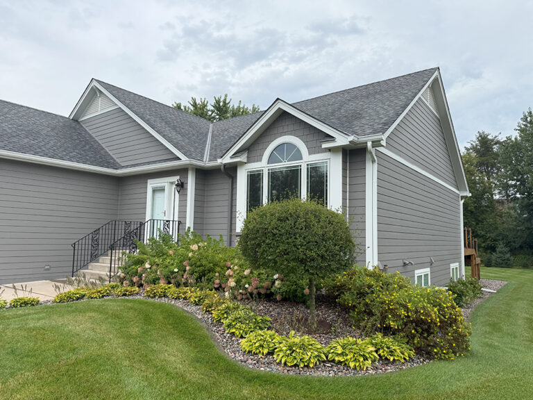 James Hardie siding and shakes in Aged Pewter with cultured stone and Arctic White trim on remodeled Lino Lakes home.