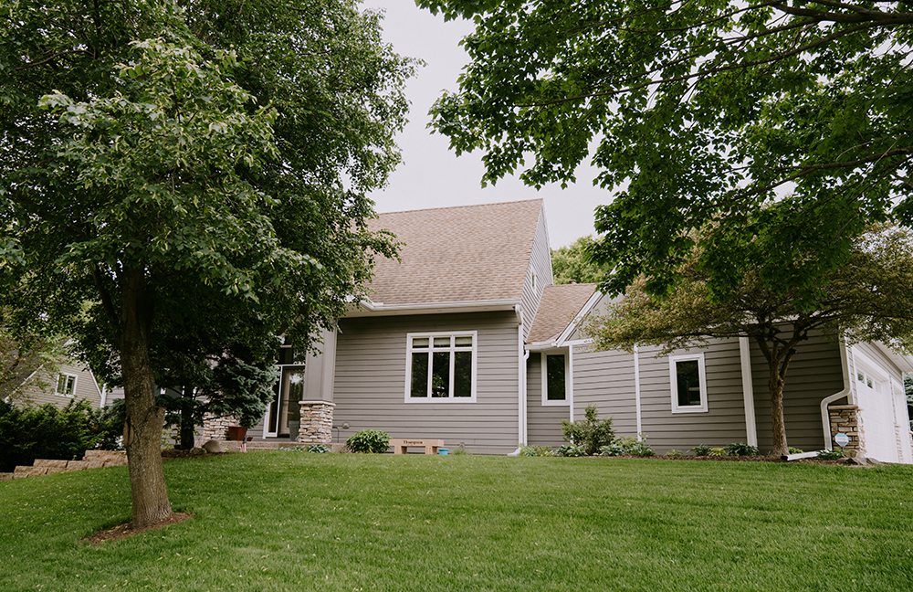 James Hardie Aged Pewter lap siding with Arctic White trim and cultured stone exterior renovation in Eden Prairie MN