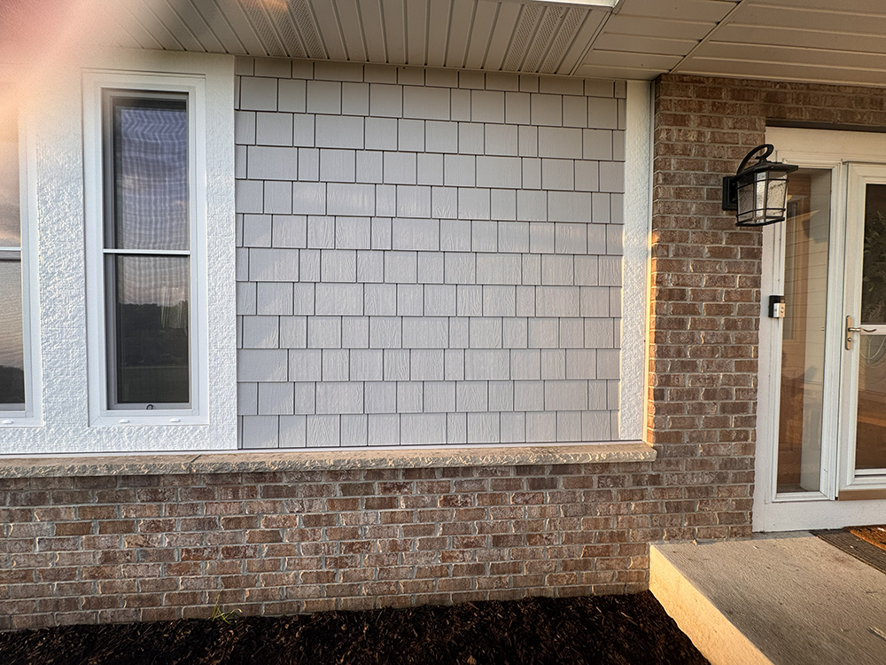 Pearl Gray James Hardie straight-edge shakes beside brick on Muskego WI home