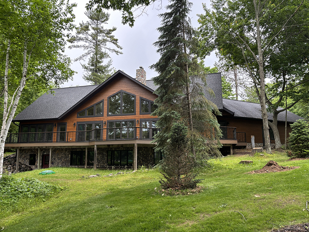Lake-facing exterior with wood-look fiber cement siding and black trim