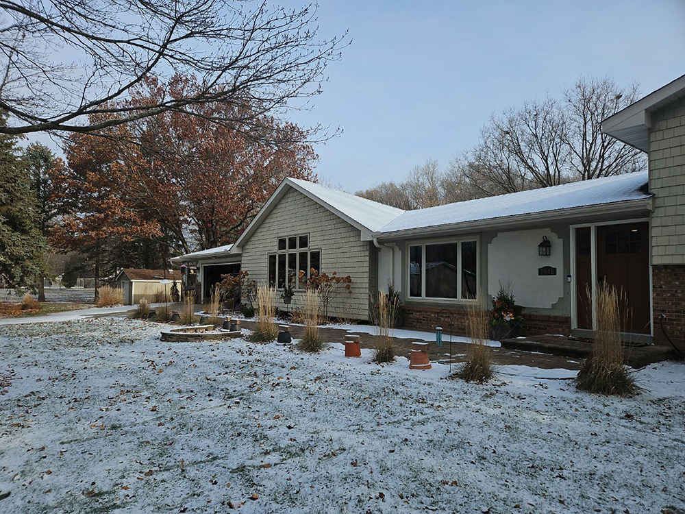 Circle Pines home before exterior siding and window replacement and new portico